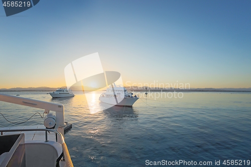 Image of Luxury yacht docking near coral reef