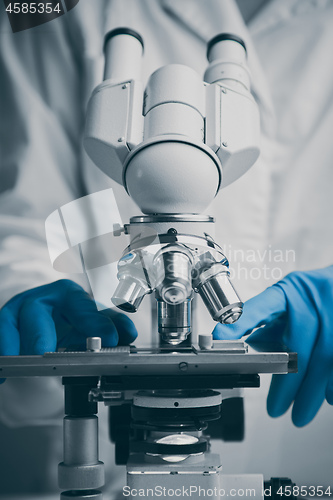 Image of Close-up shot of microscope with metal lens at laboratory.