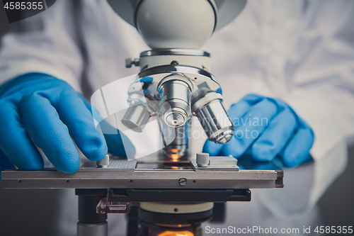Image of Close-up shot of microscope with metal lens at laboratory.