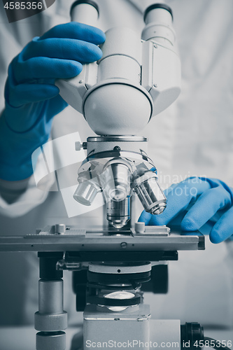 Image of Close-up shot of microscope with metal lens at laboratory.