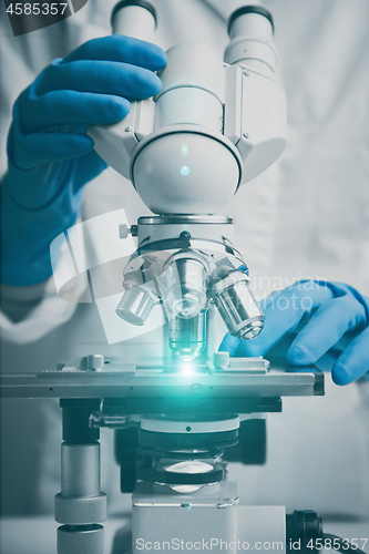 Image of Close-up shot of microscope with metal lens at laboratory.