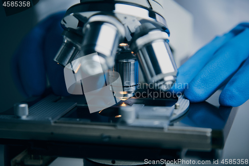 Image of Close-up shot of microscope with metal lens at laboratory.