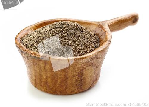 Image of black pepper in wooden cup