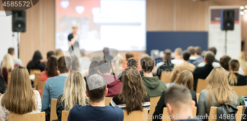 Image of Female speaker giving presentation on business conference.