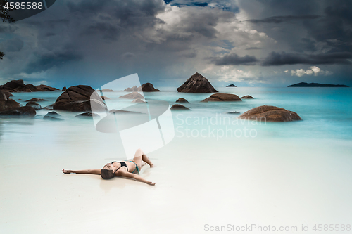 Image of Woman relaxing at the beach