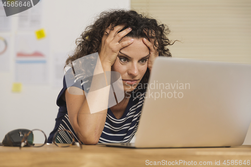 Image of Exausted woman at the office