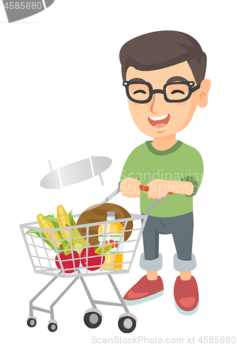 Image of Little caucasian boy with his shopping trolley.