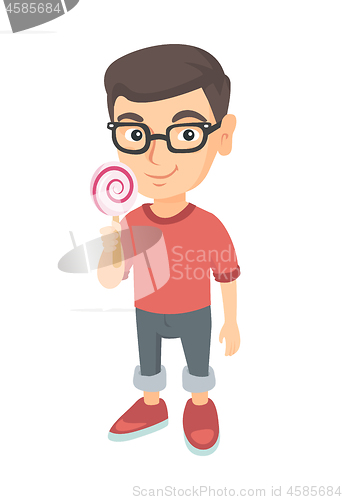 Image of Little caucasian boy holding a lollipop candy.