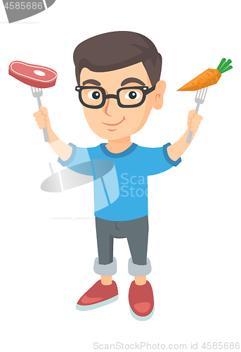 Image of Caucasian boy holding fresh carrot and steak.