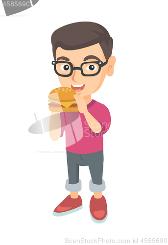 Image of Little caucasian boy eating a hamburger.