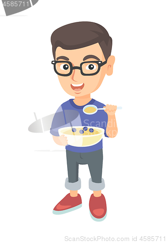 Image of Happy boy holding a spoon and bowl of porridge.