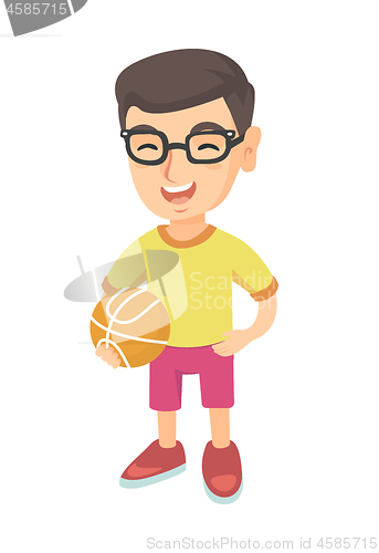 Image of Laughing schoolboy holding a basketball ball.
