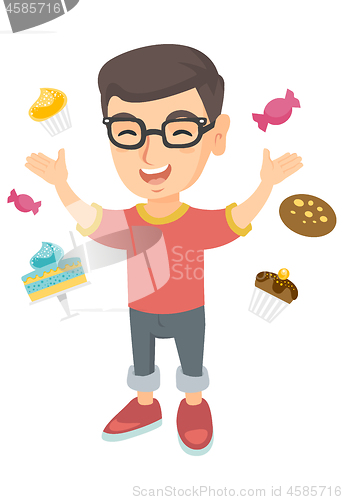 Image of Happy caucasian boy standing among lots of sweets.