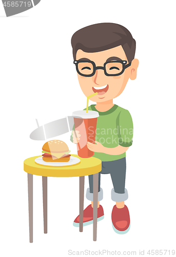 Image of Little boy drinking soda and eating cheeseburger.