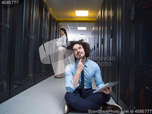 Image of young technicians working together on servers