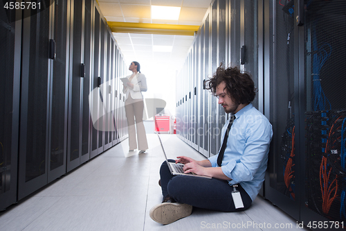 Image of Team of young technicians working together on servers