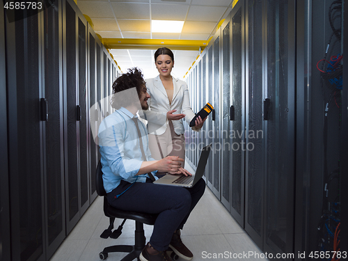 Image of technicians working together on servers