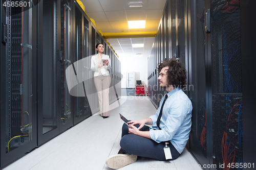 Image of young technicians working together on servers