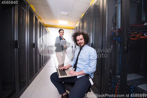 Image of Team of young technicians working together on servers