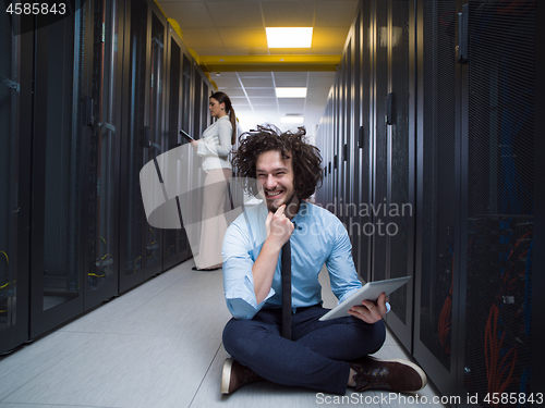 Image of young technicians working together on servers