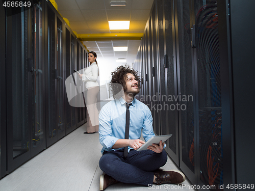 Image of young technicians working together on servers