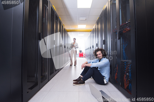 Image of Team of young technicians working together on servers