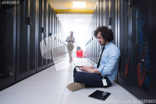 Image of Team of young technicians working together on servers