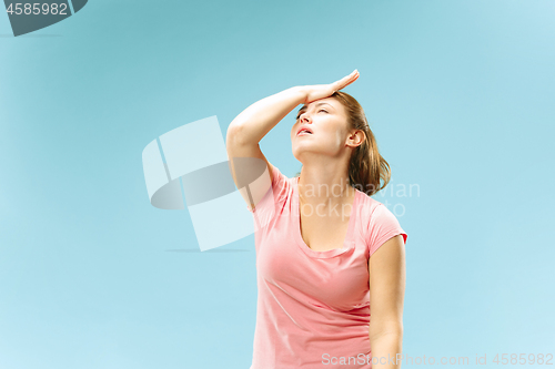 Image of Woman having headache. Isolated over pastel background.