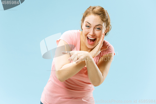 Image of The happy business woman standing and smiling against pastel background.