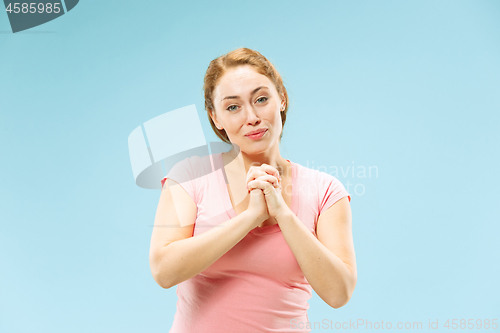 Image of The happy business woman standing and smiling against pastel background.