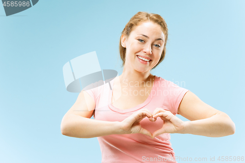 Image of Portrait of attractive cute girl with bright makeup with kiss isolated over blue background