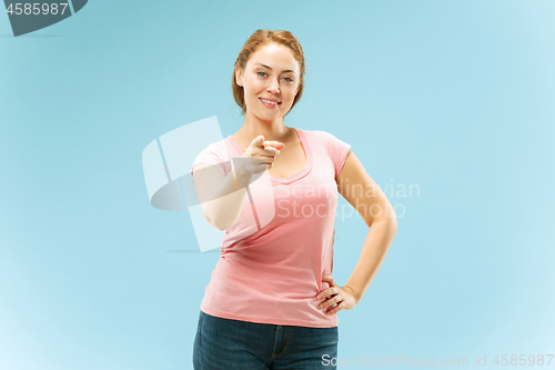 Image of The happy business woman point you and want you, half length closeup portrait on blue background.