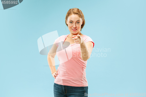 Image of The happy business woman point you and want you, half length closeup portrait on blue background.