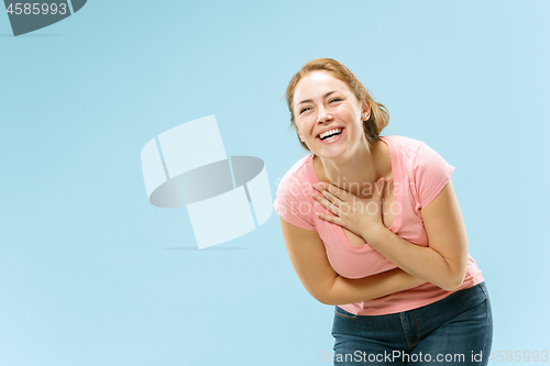 Image of The happy business woman standing and smiling against pastel background.