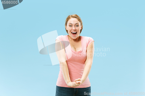 Image of The happy business woman standing and smiling against pastel background.