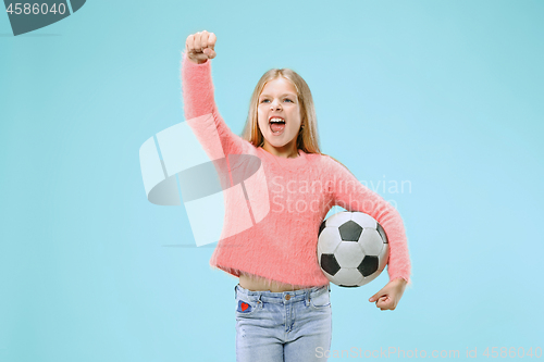 Image of Fan sport teen player holding soccer ball isolated on blue background