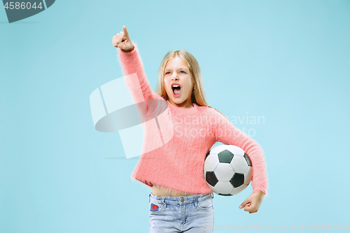 Image of Fan sport teen player holding soccer ball isolated on blue background