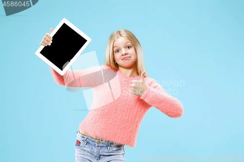 Image of Little funny girl with tablet on blue background