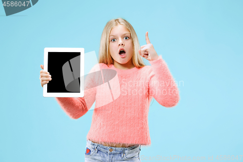 Image of Little funny girl with tablet on blue background