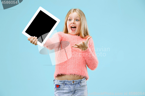 Image of Little funny girl with tablet on blue background