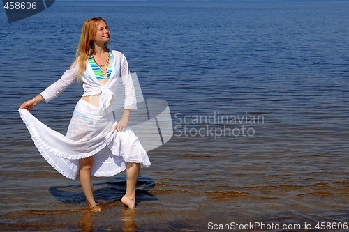 Image of Pretty girl dancing in water