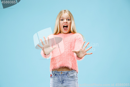 Image of Portrait of the scared girl on blue
