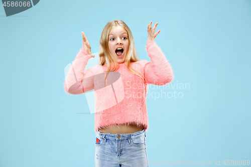 Image of Beautiful teen girl looking suprised isolated on blue