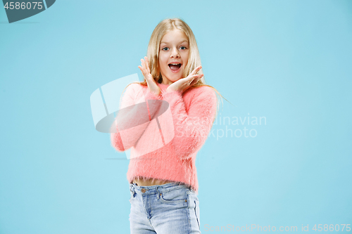 Image of Beautiful teen girl looking suprised isolated on blue