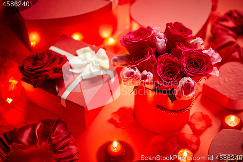 Image of Valentines day romantic decoration with roses, boxed gifts, candles