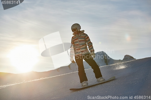 Image of Snowboarder in sun flare, water drops on lens