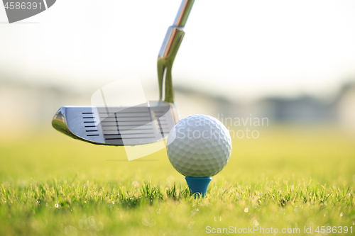 Image of Golf ball on tee in front of driver