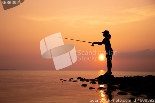 Image of Woman fishing on Fishing rod spinning in Norway.