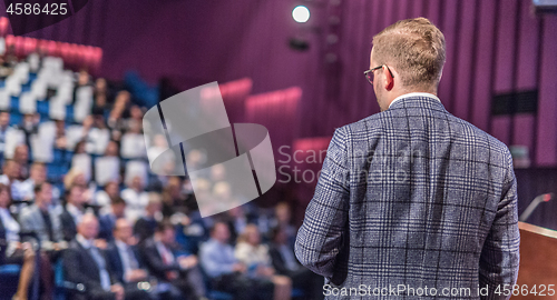 Image of Public speaker giving talk at Business Event.