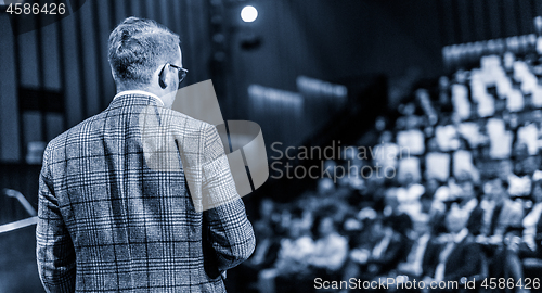 Image of Public speaker giving talk at Business Event.